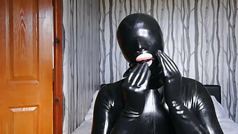 Latex-Clad Slave Endures Blindfold, Gag, And Gas Mask